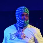 BossMan Dlow Freaks Out Over Leaked Photo Showing Him Covered Only By Luggage